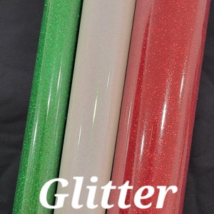 May include: Three rolls of glitter adhesive vinyl in green, white, and red.