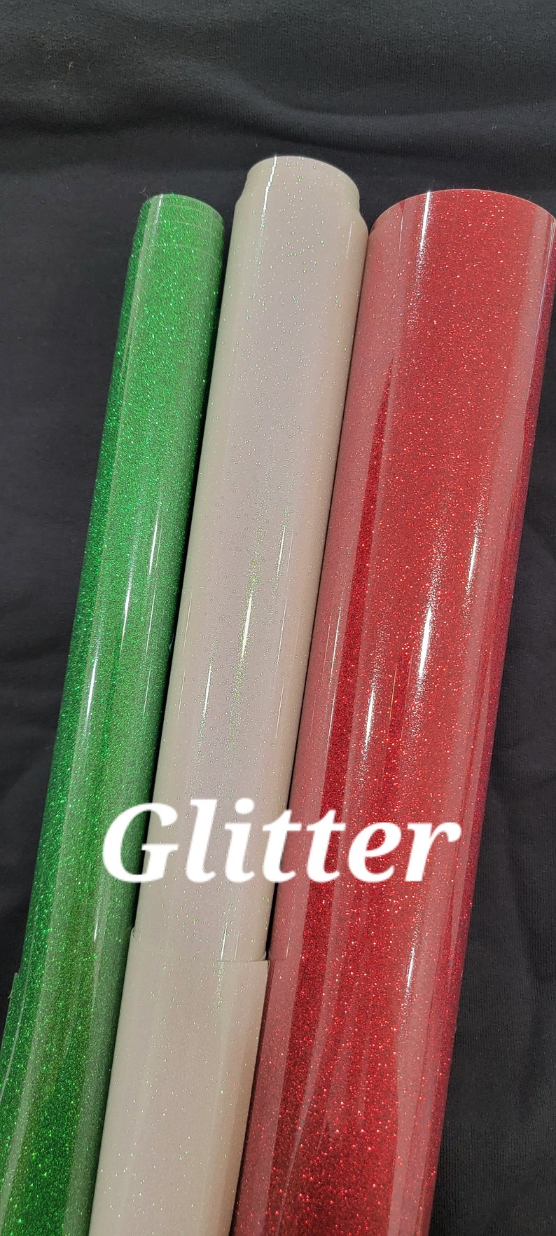 May include: Three rolls of glitter adhesive vinyl in green, white, and red.