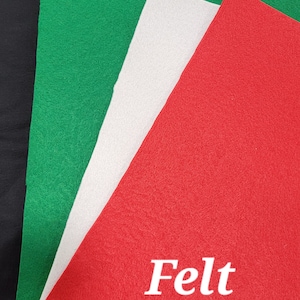 May include: Three sheets of felt in red, white, and green. The red sheet has the word "Felt" printed in white.