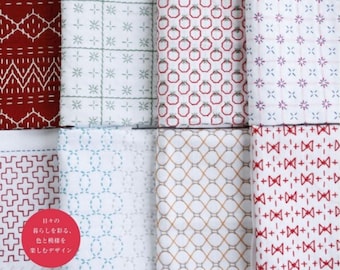 May include: A collection of eight different hand-stitched dishcloths with various geometric patterns in red, blue, and white. The cloths are made with a simple stitch pattern and are perfect for adding a touch of handmade charm to your kitchen.