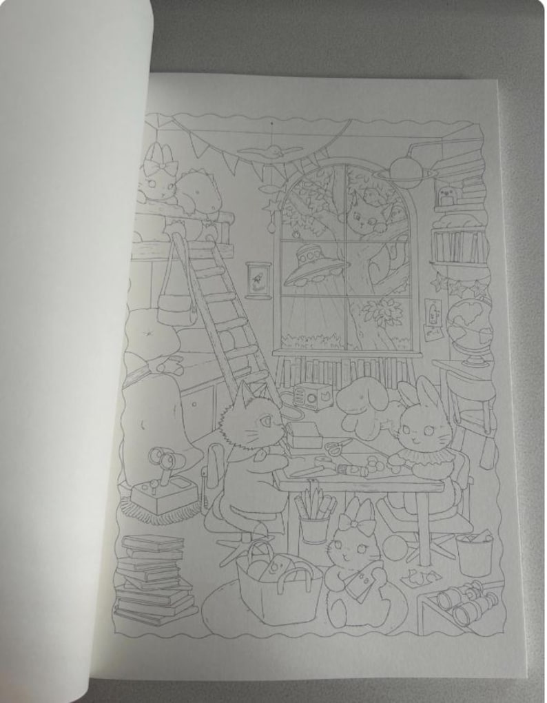 May include: A detailed black and white illustration of a coloring book page. The scene depicts a cozy room with cartoon animals, including cats and rabbits, engaged in various activities. A ladder, books, and a window with a tree are also visible.