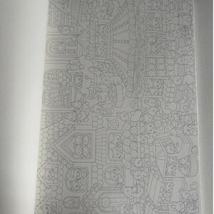 May include: A partially open coloring book featuring detailed line art illustrations. The drawings depict a whimsical scene with houses, animals, and various decorative elements. The pages are white, and the illustrations are in black and white.
