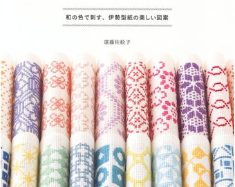 May include: A book cover titled "クロスステッチで楽しむ きもの模様" featuring rows of white fabric strips embroidered with colorful geometric cross-stitch patterns in shades of orange, purple, pink, green, blue, and yellow, with Japanese text.