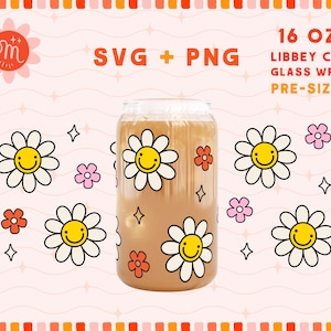 May include: A 16 oz. Libbey can glass wrap with a pre-sized design featuring a repeating pattern of white daisies with yellow centers and smiling faces. The daisies are on a brown background with orange and pink flowers.