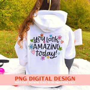 May include: White hoodie with a colourful floral design and the text "You look amazing today!" printed on the back.