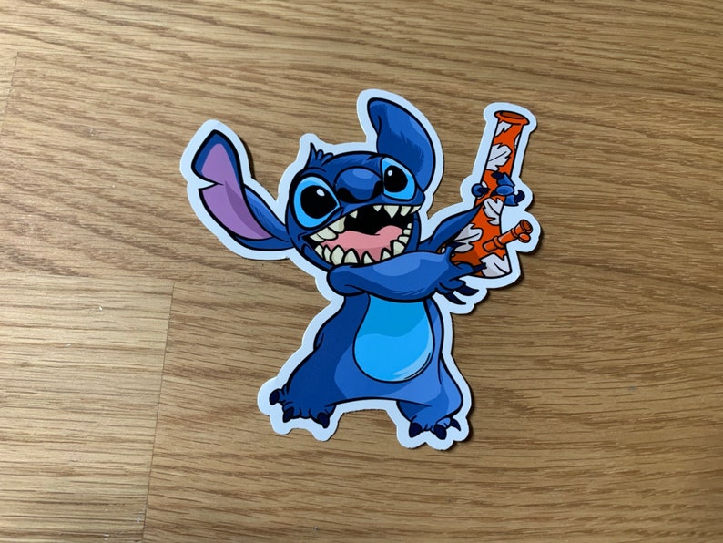 May include: A blue cartoon character with three fingers holding a red and white bong. The character has a wide grin and large, blue eyes.