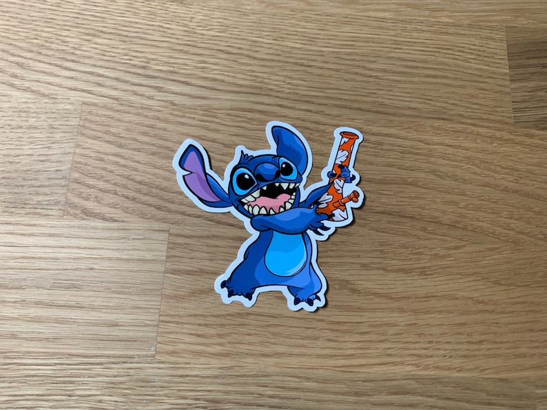 May include: A blue cartoon character with three fingers holding a glass bong with orange and white designs. The character has a big smile and is wearing a blue shirt.