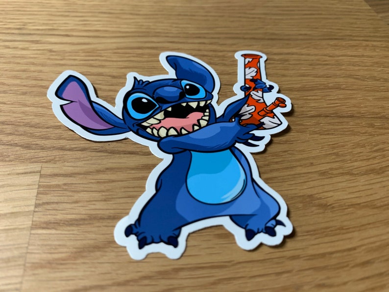 May include: A blue cartoon character with three fingers on each hand holding a red and white glass bong. The character has a wide grin and large eyes.