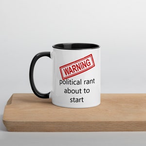May include: White ceramic mug with a black rim and handle. The mug has a red warning stamp that says "WARNING" and the text "political rant about to start".