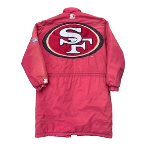 May include: A red vintage Starter jacket with a large San Francisco 49ers logo on the back. The jacket has a drawstring waist and a zipper closure.