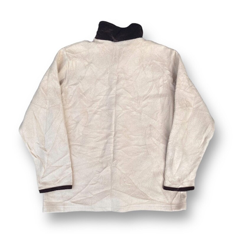 May include: A cream-colored fleece pullover with a black collar and black trim on the sleeves.
