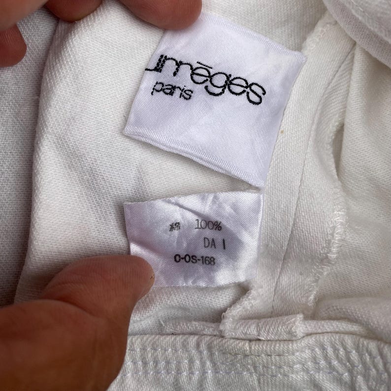 May include: White cotton t-shirt with a white tag that says "Im&egrave;ges Paris" and a white tag that says "100% DA I C-OS-168"