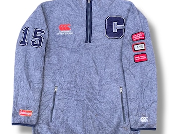 Suéter de forro polar con media cremallera Canterbury Steinlager World Toughest Wear de los años 90, estilo vintage de los All Blacks de Nueva Zelanda, con logo bordado de la marca Polartec, talla L.