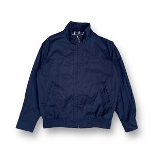 May include: A dark blue zip-up jacket with a stand-up collar and a ribbed hem.