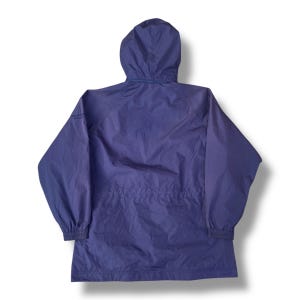 May include: A navy blue hooded jacket with a drawstring waist and elastic cuffs. The jacket has a full zipper and a hood. The jacket is made of a lightweight, water-resistant material.