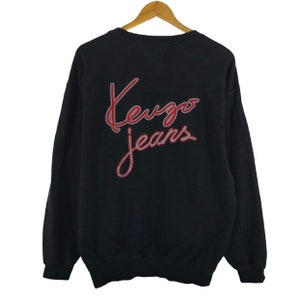May include: Black sweatshirt with a red and white "Kenzo Jeans" logo on the back.