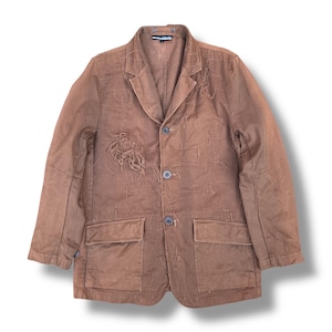 May include: A brown blazer with a notched collar, two front pockets, and three buttons. The jacket has a unique stitched design and a distressed patch on the front. The blazer is a medium weight and appears to be made of cotton or a similar fabric.