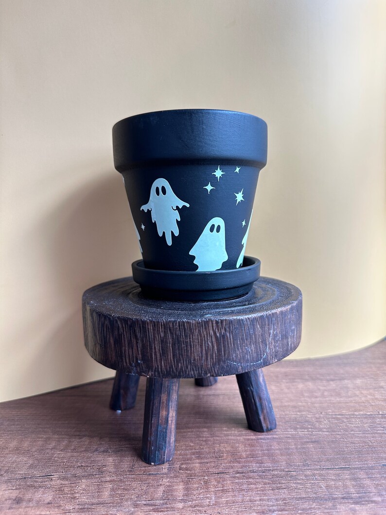 Glow in the dark ghost planter. Black planter with ghosts, stars and crescent moon fully wrapped for a haunted garden.