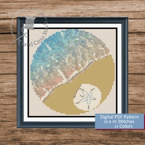 May include: A cross stitch pattern featuring a seashell on a beach with blue and yellow colors. The pattern is 65 x 65 stitches and uses 15 colors. Digital PDF Pattern 65 x 65 Stitches 15 Colors