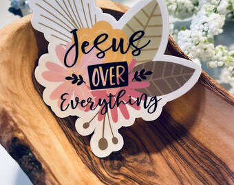 May include: A sticker with a floral design and the text "Jesus Over Everything".