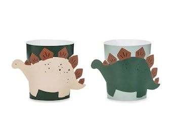 May include: Two paper cups with dinosaur designs. The cups are green and blue with brown dinosaur silhouettes. One dinosaur is beige and the other is green.