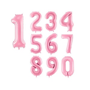 May include: Pink foil number balloons, 1 through 0, for a party or celebration.