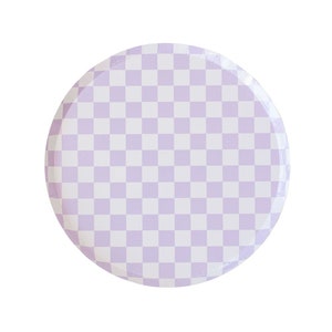 May include: A round, white paper plate with a checkered pattern in a light purple colour.