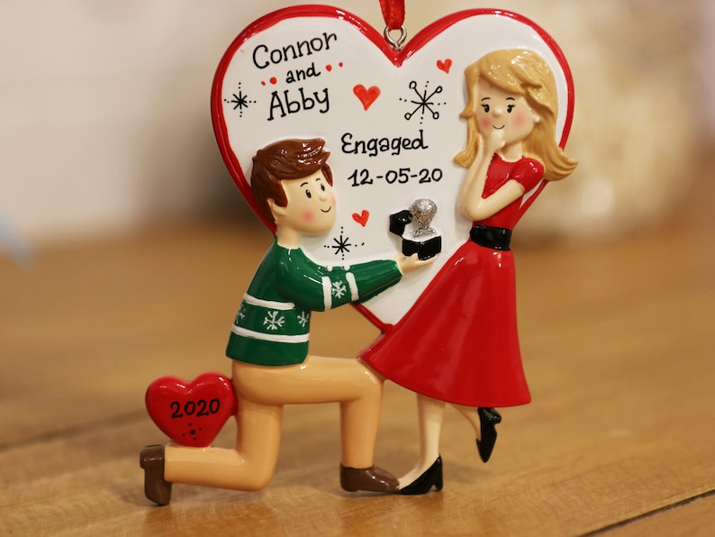 hand personalized	family ornament	custom ornament	christmas ornament	engagement ornament	engaged couple	engagement gift	proposal ornament	first christmas	natlandia	bestseller	we are engaged	marry me