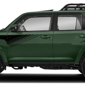 May include: A green Toyota 4Runner with black side stripes and a roof rack. The vehicle has black wheels and a black trim around the windows.