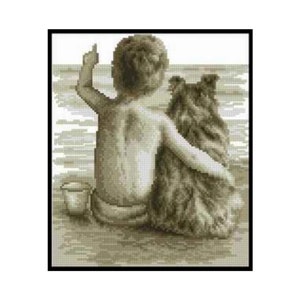 Könnte beinhalten: Ein Schwarzweiß-Kreuzstichmuster eines Kindes und eines Hundes, die am Strand sitzen. Das Kind zeigt mit der rechten Hand und der Hund schaut nach rechts.