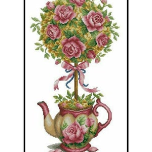 May include: A cross-stitch design of a teapot with a floral arrangement. The teapot is beige and pink, decorated with rose motifs. Above, a topiary of pink roses and green foliage is tied with a pink ribbon.