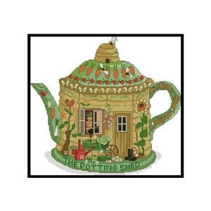 May include: A green teapot shaped like a potting shed with a brown roof and a beehive on top. The teapot has a window with a black cat looking out, and the words "Spring, Summer, Autumn, Winter" are written on the side. The teapot is sitting on a green base with the words "The Potting Shed" written on it.