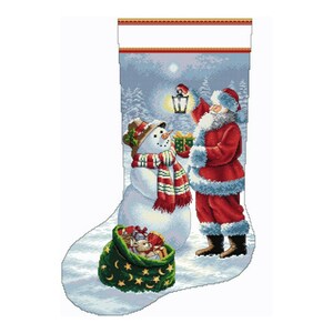 May include: A Christmas stocking with a snowy scene featuring Santa Claus holding a lantern and a snowman with a red and green scarf. The stocking is filled with presents and a small stuffed animal.