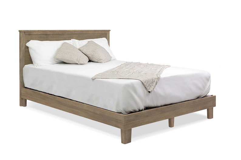 May include: A wooden bed frame with a white mattress and two pillows. The bed frame is a light brown color and has a simple design.