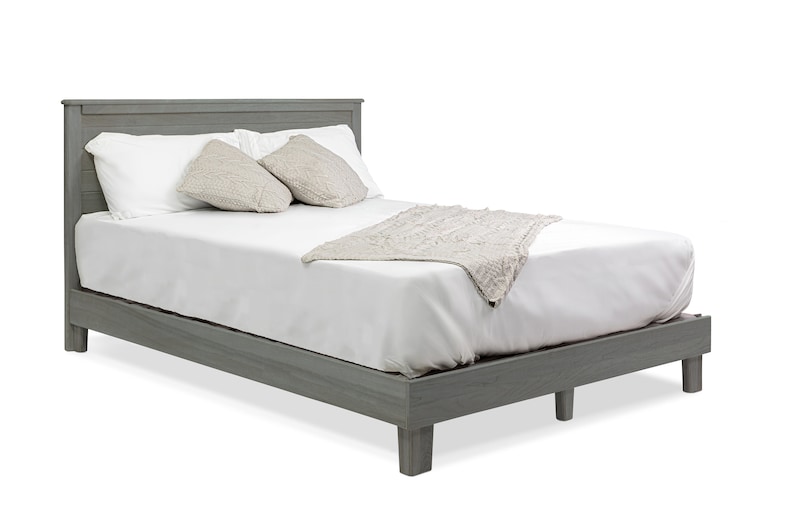 May include: A gray wooden platform bed frame with a white mattress, two pillows, and a white throw blanket.