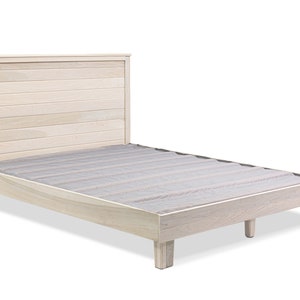 May include: A light wood platform bed frame with a slatted headboard. The bed frame has a simple design and is made of solid wood.