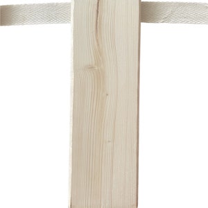 May include: A close-up of a light brown wooden post with a white fabric strap wrapped around it.