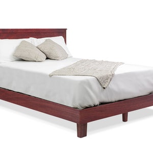 May include: A dark red wooden bed frame with a white mattress and a white blanket. The bed has a headboard and footboard.