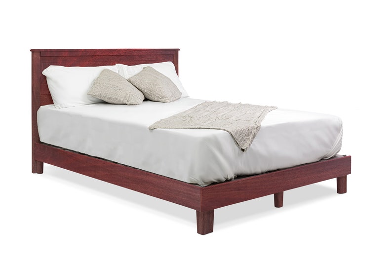 May include: A dark red wooden bed frame with a white mattress and a white blanket. The bed has a headboard and footboard.