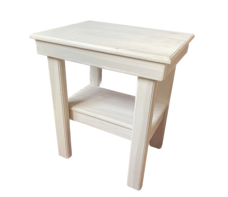 May include: A white wooden end table with a shelf. The table has a simple design with straight lines and a smooth finish.