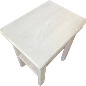 May include: White wooden end table with a shelf. The table has a simple design with a rectangular top and legs.