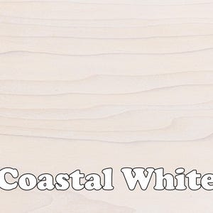 May include: Close-up of a light wood surface with a grainy texture. The wood is painted a light white color and the text "Coastal White" is printed in white on the surface.