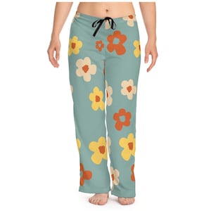 May include: Blue pajama pants with a pattern of orange, yellow, and white flowers.