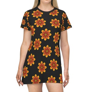May include: A black t-shirt dress with a retro floral pattern in shades of orange, yellow, and red. The flowers are stylized and have a 1970s vibe.
