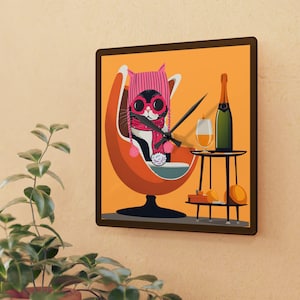 May include: A black and white cat wearing pink sunglasses and a pink hat sits in an orange egg-shaped chair. The cat is holding a glass of champagne and there is a bottle of champagne on a small table next to the chair.