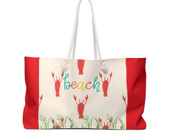 May include: A large beach tote bag with a cream-colored center featuring red lobsters and the word "beach" in turquoise and yellow. The sides are red, and the bag has white rope handles.