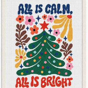 May include: A cross-stitch embroidery on white fabric featuring a green Christmas tree with colorful ornaments and a red star topper. The text "ALL IS CALM," in blue and "ALL IS BRIGHT" in red surrounds the tree, accented by floral motifs.