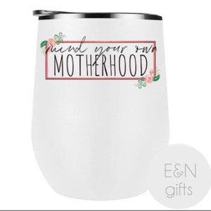 May include: White stainless steel wine tumbler with a pink floral design and the text "Mind your own motherhood" in a pink box.
