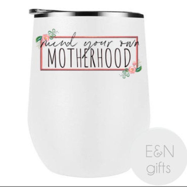 May include: White stainless steel wine tumbler with a pink floral design and the text "Mind your own motherhood" in a pink box.