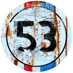 May include: A rusty, blue, red, and white round metal sign with the number 53 in black.